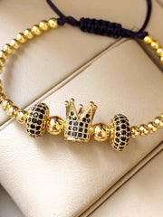 Bratara model margele aurii si coroana cu pietricele negre